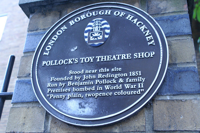 Pollock's Toy Theatre Shop, John Redington, and Benjamin Pollock plaque - Pollock's Toy Theatre Shop Stood near this site  Founded by John Redington 1851  Run by Benjamin Pollock & family  Premises bombed in World War II  “Penny plain, twopence coloured”