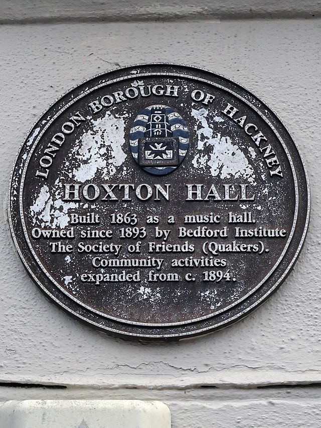 Brown plaque № 8585 - Hoxton Hall  Built 1863 as a music hall.  Owned since 1863 by Bedford Institute.  The Society of Friends (Quakers)  Community activities  expanded from c 1894