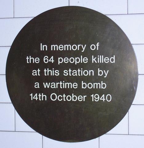 Black plaque № 11725 - In memory of the 64 people killed at this station by a wartime bomb 14th October 1940