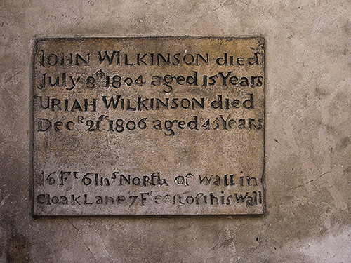 John Wilkinson and Uriah Wilkinson white plaque - John Wilkinson died July 8th 1804 aged 15 years Uriah Wilkinson died Dec 21st 1806 aged 45 years. 16 Ft 6 Ins north of wall in Cloak Lane 7 feet east of this wall