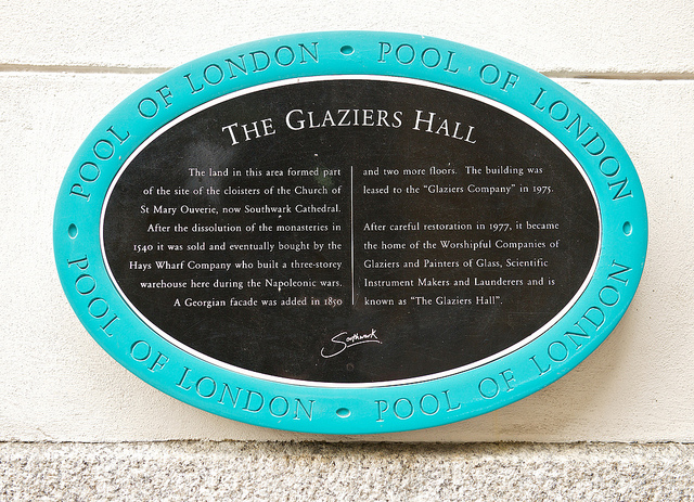 Black plaque № 30190 - The Glaziers Hall. The land in this area formed part of the site of the cloisters of the Church of St Mary Ouverie, now Southwark Cathedral. After the dissolution of the monasteries in 1540 it was sold and eventually bought by the Hays Wharf Company who built a three-storey warehouse here during the Napoleonic wars. A Georgian facade was added in 1830 and two more floors. The building was leased to the 
