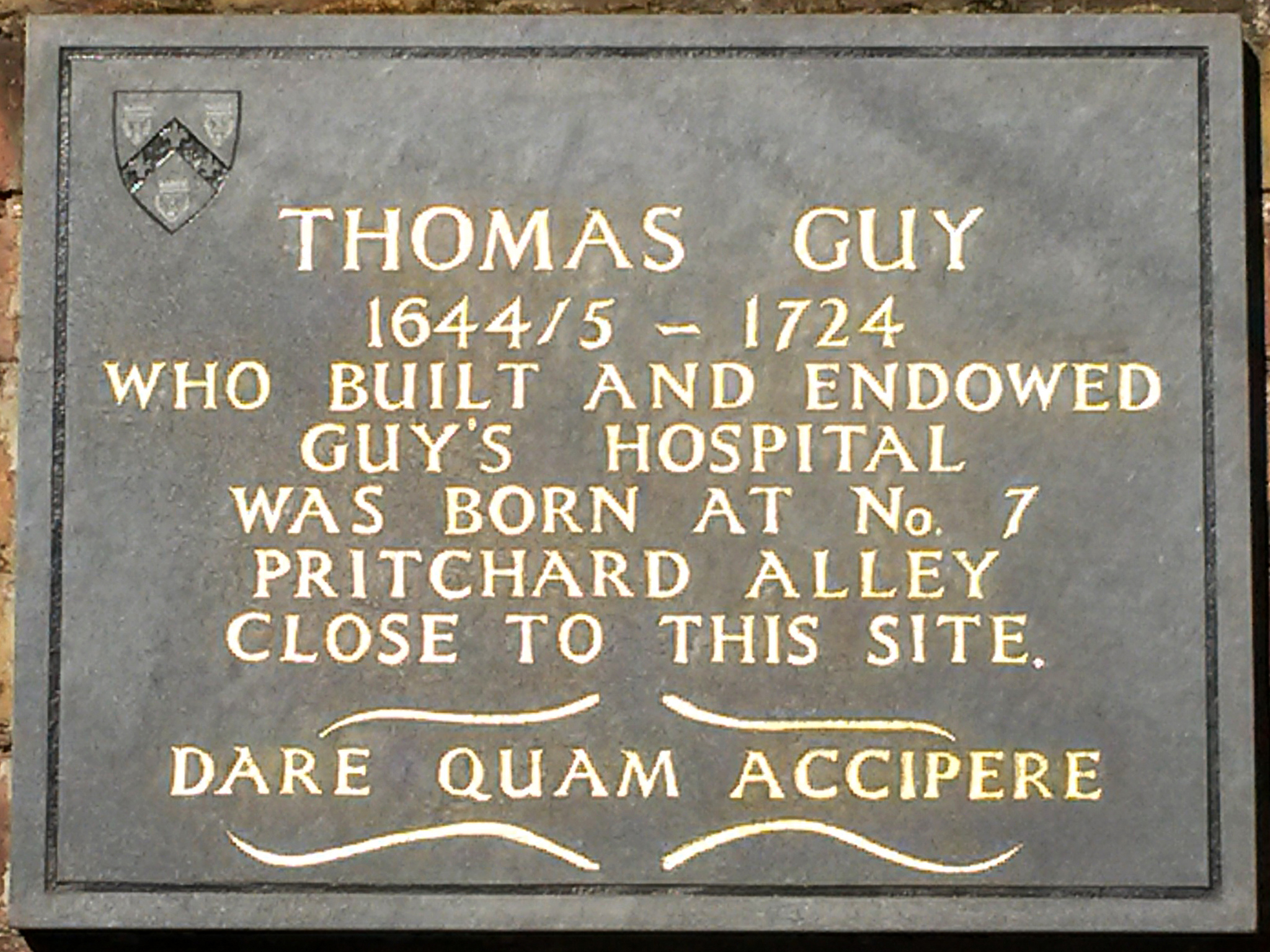 Thomas Guy grey plaque - Thomas Guy 1644/5-1724 who built and endowed Guy's Hospital was born at No.7 Pritchard Alley close to this site. Dare quam accipere