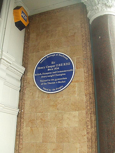 Henry Cooper blue plaque - Sir Henry Cooper OBE KSG born 1934 British, European and Commonwealth Heavyweight Champion trained in the gymnasium of the Thomas a Becket      