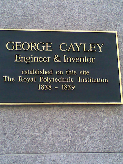 George Cayley black plaque - George Cayley engineer & inventor established on this site the Royal Polytechnic Institution 1838-1839