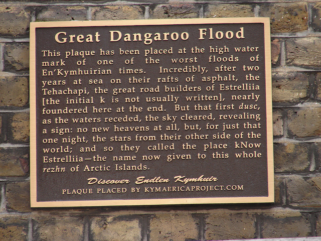 Brown plaque № 4986 - Great Dangaroo Flood This plaque has been placed at the high water mark of one of the worst floods of En'Kymhuirian times. Incredibly, after two years at sea on their rafts of asphalt, the Tehachapi, the great road builders of Estrelliia [the initial k is not usually written], nearly foundered here at the end. Bust that first dusc, as the water receded, the sky cleared, revealing a sign: no new heavens at all, but, for just that one night, the stars from their other side of the world; and so the