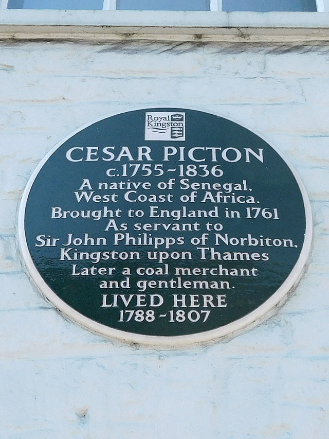 Cesar Picton black plaque - Cesar Picton c.1755-1836 a native of Senegal, West Coast of Africa. Brought to England in 1761 as a servant to Sir John Philipps of Norbiton, Kingston upon Thames. Later a coal merchant and gentleman lived here 1788-1807