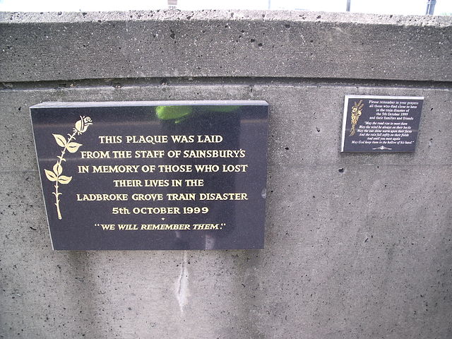 Ladbroke Grove Train Disaster black plaque - This plaque was laid from the staff at Sainsbury's in memory of those lost in the Ladbroke Grove Train Disaster 5th October 1999. 