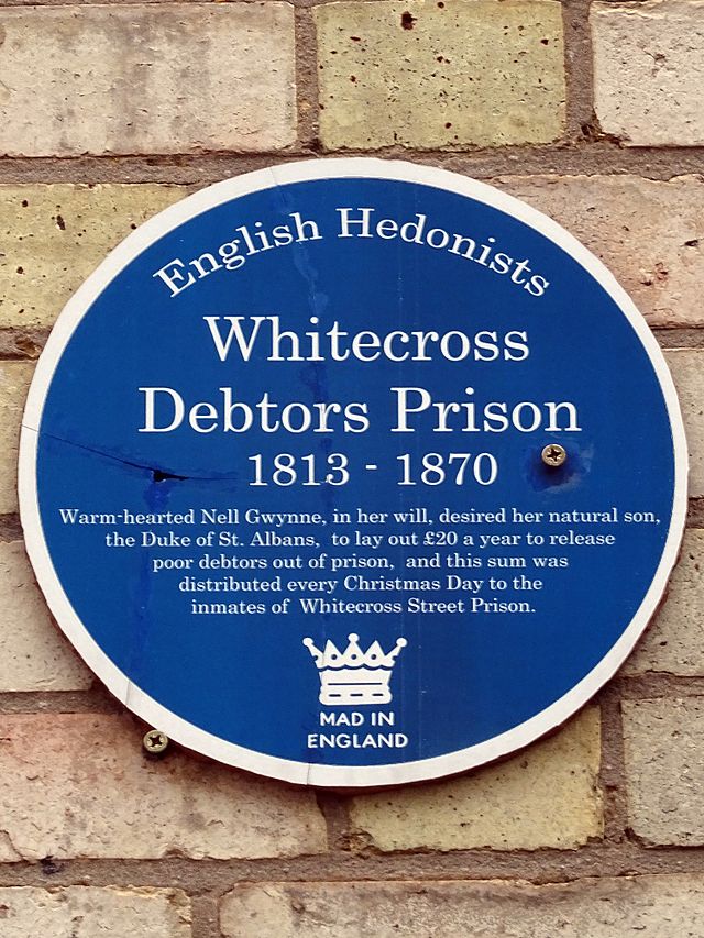 Debtors Prison, Whitecross blue plaque - Whitecross Debtors Prison 1813 - 1870 warm-hearted Nell Gwynne, in her will, desired her natural son the Duke of St. Albans, to lay out £20 a year to release poor debtors out of prison, and this sum was distributed every Christmas Day to the inmates of Whitecross Street Prison.