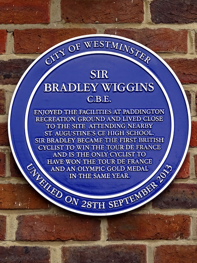 Bradley Wiggins blue plaque - Sir Bradley Wiggins CBE enjoyed the facilities at Paddington Recreation Ground and lived close to the site attending nearby St.Augustine's CE High School. Sir Bradley became the first British cyclist to win the Tour de France and is the only cyclist to have won the Tour de France and an Olympic gold medal in the same year.