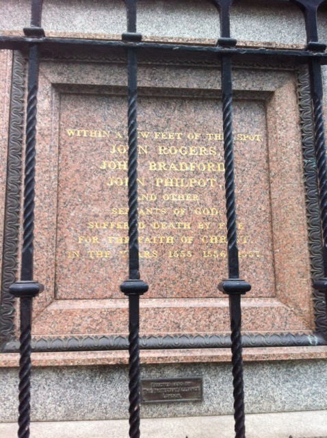John Rogers, John Bradford, and John Philpot red plaque - Within a few feet of this spot John Rogers, John Bradford, John Philpot and other servants of God suffered death by fire for the faith of Christ in the years 1555, 1556, 1557