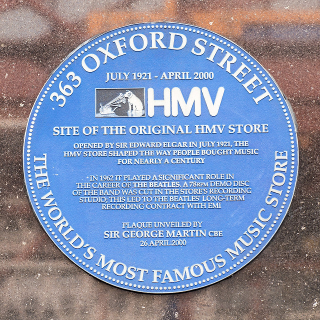 The Beatles and Edward Elgar blue plaque - 363 Oxford Street  July 1921 - April 2000  HMV  Site of the original HMV store  Opened by Sir Edward Elgar in July 1921, the  HMV store shaped the way people bought music  for nearly a century    In 1962 it played a significant role in the career of The Beatles. A 78RPM demo disc  of the band was cut in the store's recording  studio. This led to the Beatles' long-term  recording contract with EMI    The world's most famous music store