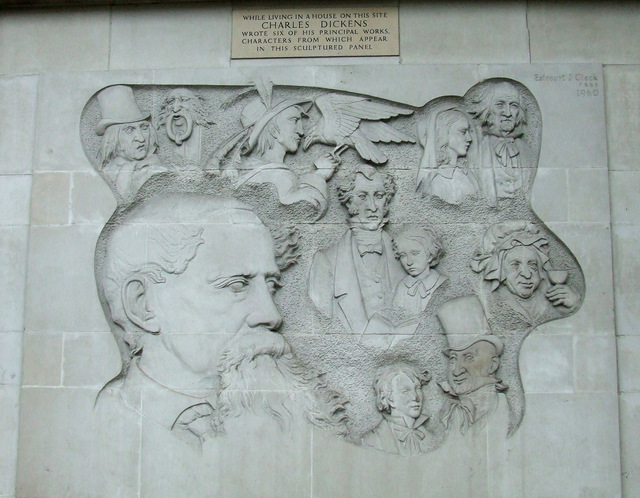 Charles Dickens white plaque - While living in a house on this site Charles Dickens wrote six of his principal works. Characters from which appear in this sculptured panel