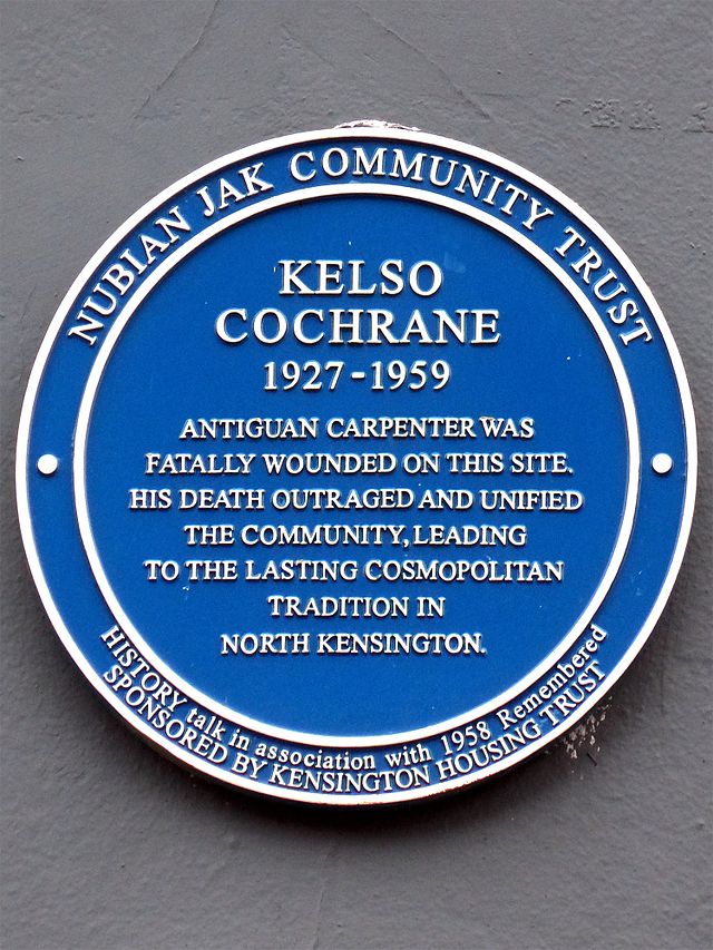 Kelso Cochrane blue plaque - Kelso Cochrane 1936-1959 Antiguan carpenter and student, was fatally wounded on this site.   His death outraged and unified the community, leading to the lasting cosmopolitan tradition in this area of North Kensington