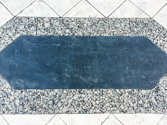 Roman Amphitheatre black plaque - The arena of London's Roman amphitheatre beneath the Guildhall Yard is indicated by the black slate oval inlaid in the yard's paved surface