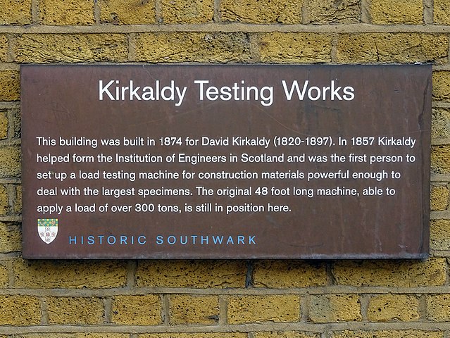 Brown plaque № 43662 - Kirkaldy Testing Works   This building was built in 1874 for David Kirkaldy (1820-1897). In 1857 Kirkaldy helped form the Institution of Engineers in Scotland and was the first person to set up a load testing machine for construction materials powerful enough to deal with the largest specimens. The original 48 foot long machine, able to apply a load of over 300 tones, is still in position today.    