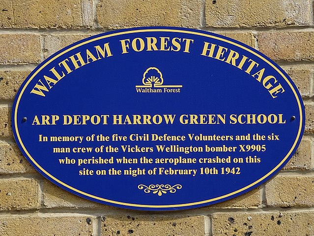 Blue plaque № 9679 - ARP depot Harrow Green School - In memory of the five local Civil Defence volunteers and the six man crew of the Vickers Wellington bomber X9905 who perished when the aeroplane crashed on this site on the night of February 10th 1942
