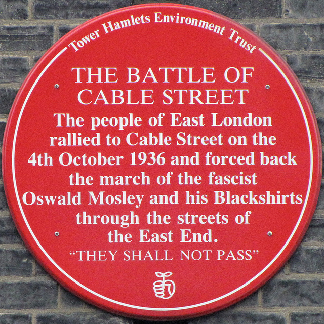 Battle of Cable Street red plaque - The Battle of Cable Street  The people of East London  rallied to Cable Street on the  4th October 1936 and forced back  the march of the fascist  Oswald Mosley and his Blackshirts  through the streets of  the East End.  They shall not pass
