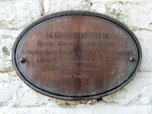 Charles Dickens bronze plaque - Charles Dickens's Wine Cellar  The wine cellar used by Charles Dickens during his time at Doughty Street has been restored and refitted with the financial assistance of national wine merchants Peter Dominic.
