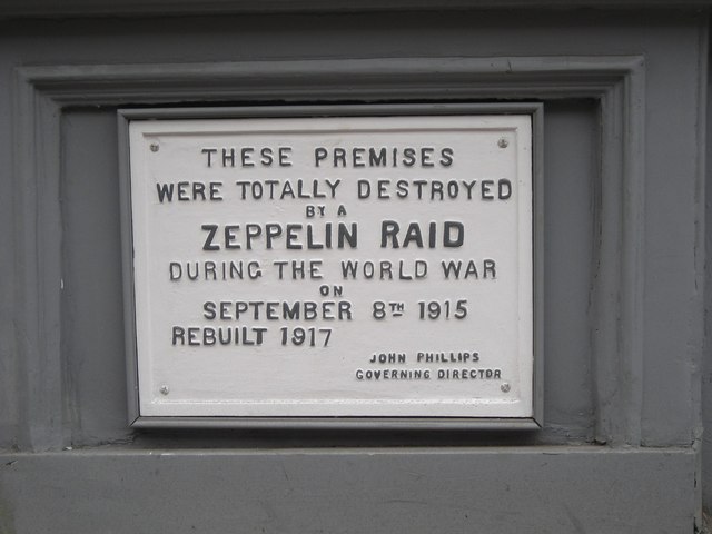 White plaque № 10094 - These premises were totally destroyed by a zeppelin raid during the World War on September 8th 1915 rebuilt 1917