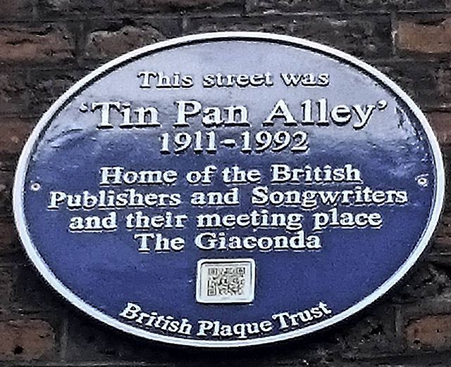Blue plaque № 31504 - This street was 'Tin Pan Alley' 1911-1992 home of the British publishers and songwriters and their meeting place The Giaconda