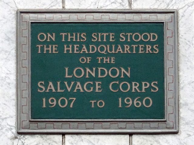 headquarters of the London Salvage Corps green plaque - On this site stood the headquarters of the London Salvage Corps 1907 to 1960